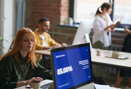 Professionals working in a stylish coworking space, focusing on growth and collaboration.