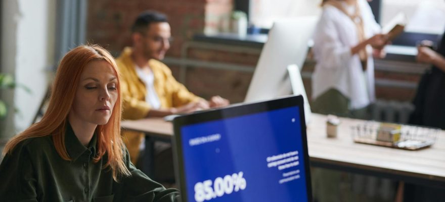 Professionals working in a stylish coworking space, focusing on growth and collaboration.