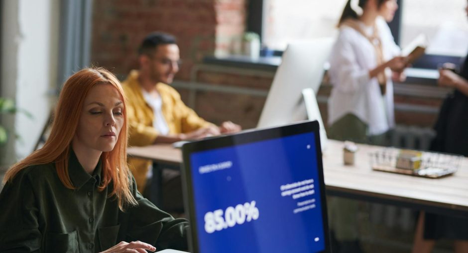 Professionals working in a stylish coworking space, focusing on growth and collaboration.
