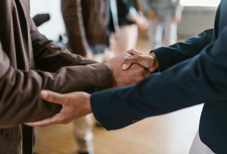 Close-up of two businesspeople shaking hands, symbolizing agreement and partnership.