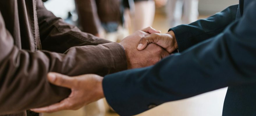 Close-up of two businesspeople shaking hands, symbolizing agreement and partnership.
