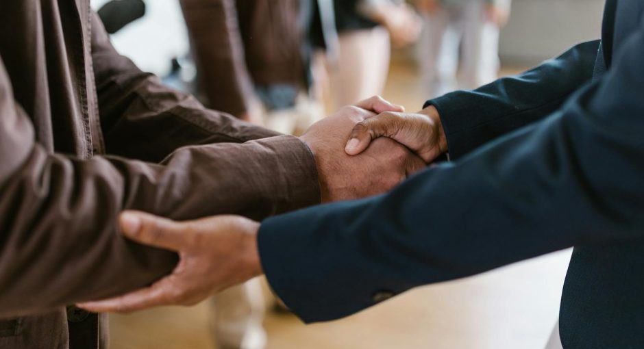 Close-up of two businesspeople shaking hands, symbolizing agreement and partnership.